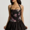 Nanala Halterneck Lace-Up Bubble Hem Mini Dress in Black Floral Print Nanala Halterneck Lace-Up Bubble Hem Mini Dress in Black Floral Print
