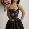 Nanala Halterneck Lace-Up Bubble Hem Mini Dress in Black Floral Print Nanala Halterneck Lace-Up Bubble Hem Mini Dress in Black Floral Print